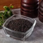 a-bowl-of-black-seed-and-a-bottle-of-vinegar-photo